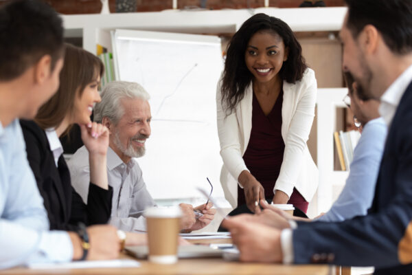 Diverse businesspeople gathered together for negotiations lead by african businesswoman Mastering EQ Level 2 - Emotional Intelligence Skill Development